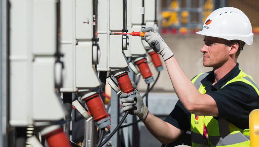 Man in hard hat fixing equipment