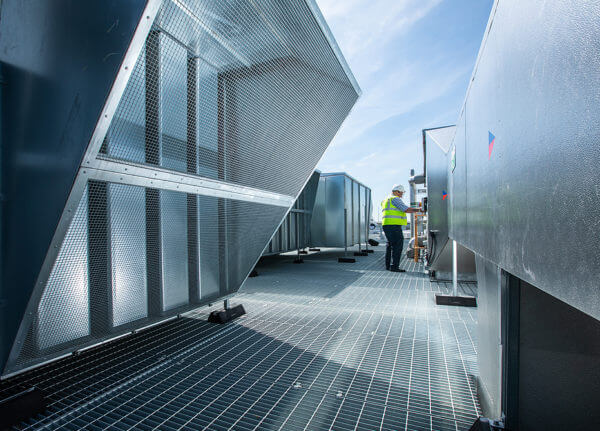 Mitie engineer servicing heat pumps and air conditioning units on a roof