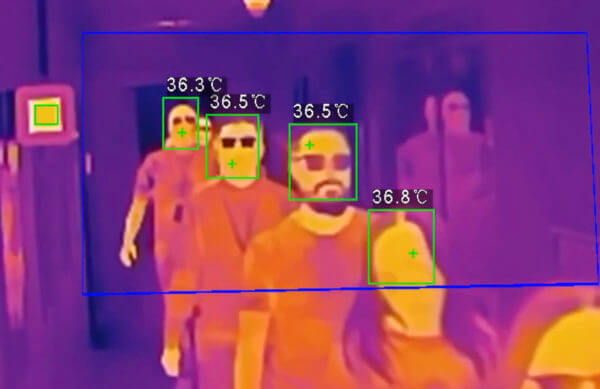 Thermal image of people entering a building, in colours of orange and purple