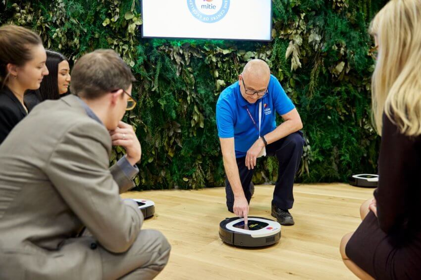 Mitie employee demonstrating how to use a robotic floor cleaner at the Centre and Hygiene Centre of Excellence