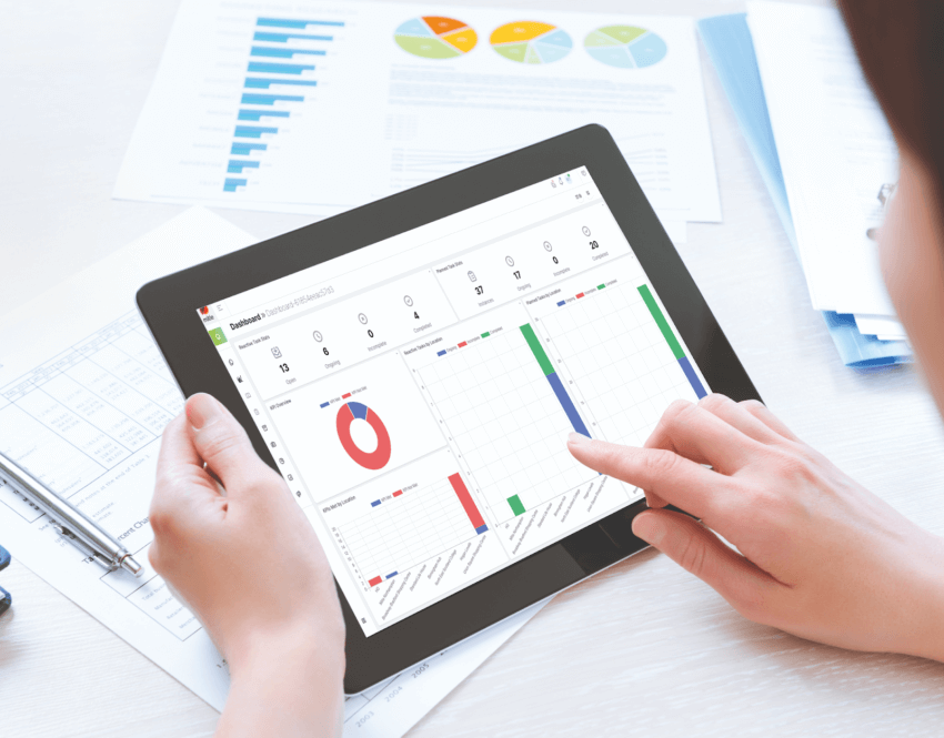 Person using iPad for work with graphs on screen