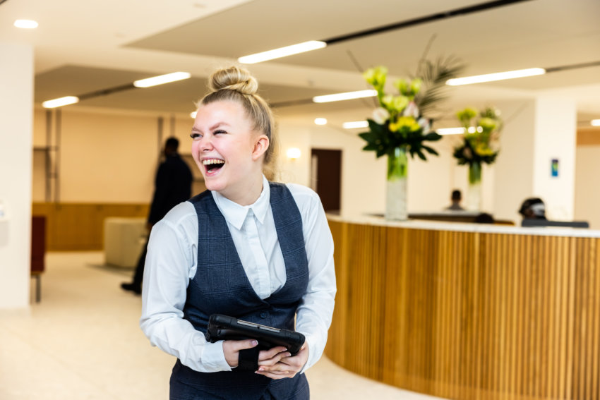 Mitie front of house female staff member laughing