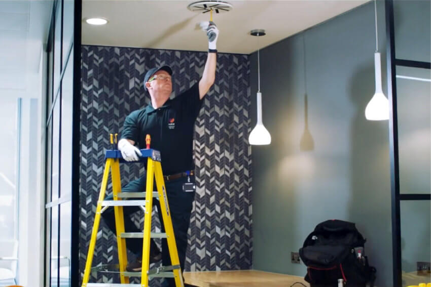 Mitie engineer checking a ceiling ventilation fan