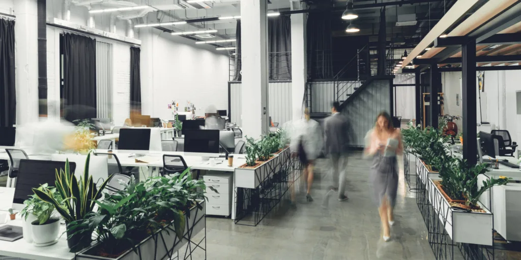 Modern open space office interior with blurred business colleagues