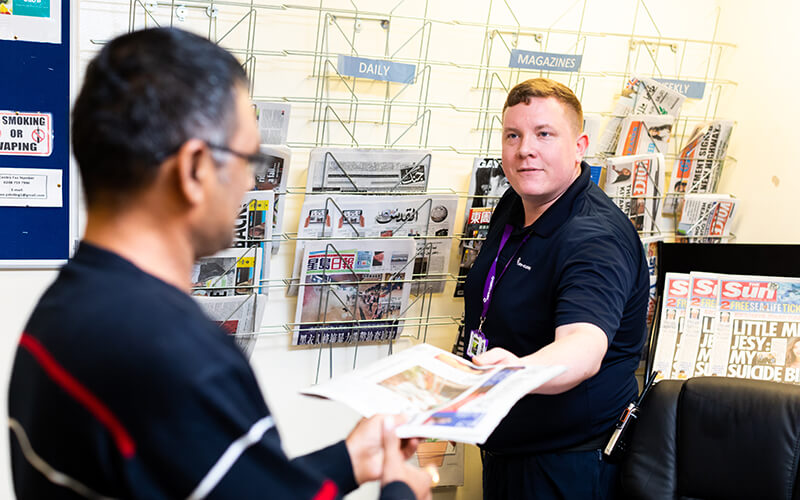 Newspapers being handed out at a detention centre