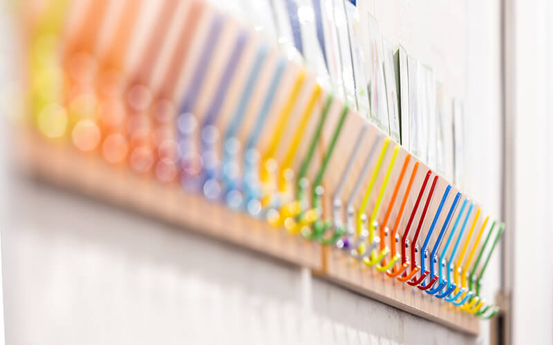 Colourful coat hooks on a wall at a school