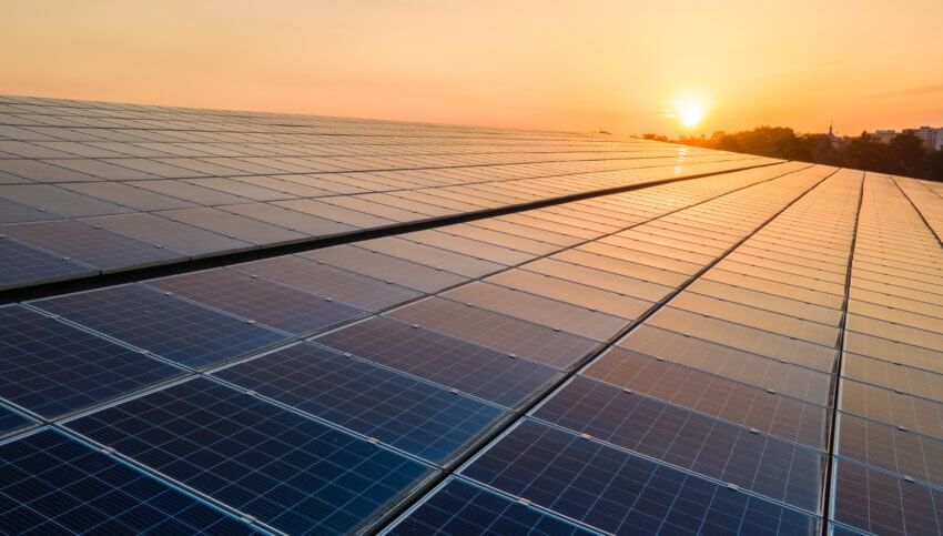 Sunrise or sunset being reflected over dark solar panels