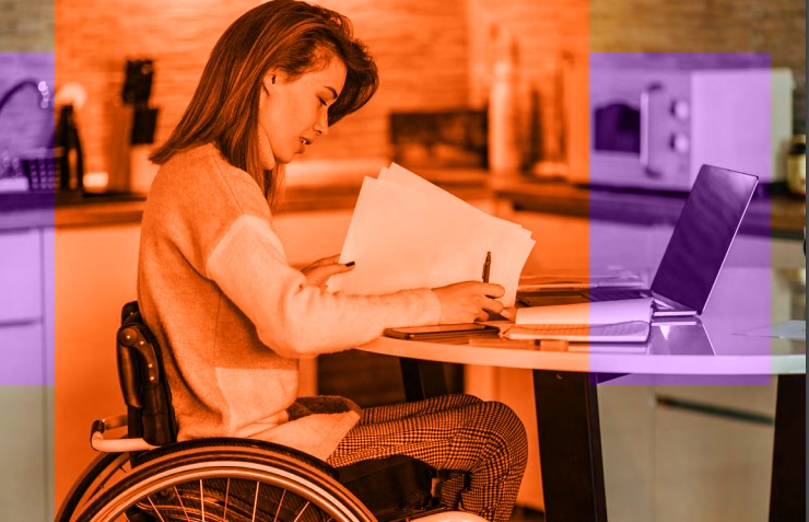 Women in a wheelchair working at home