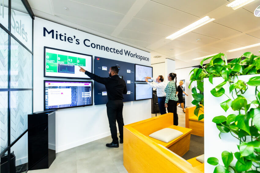 Mitie employees using interactive wall screens in the Connected Workspace
