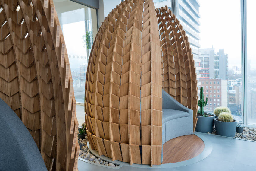Workplace 'relaxation pods' at Mitie's offices in the Shard, London (grey sofas with wooden 'cone' surrounding)