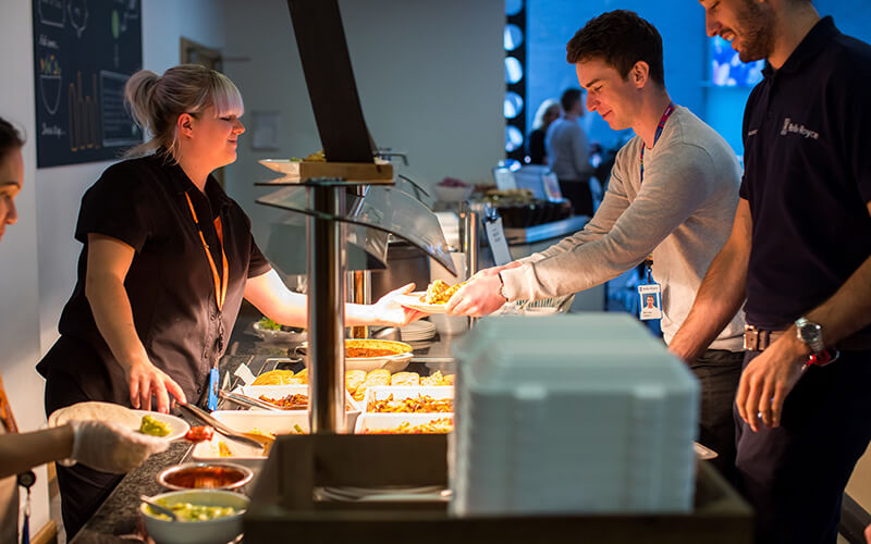 Hot food being served and chosen at a catering buffet
