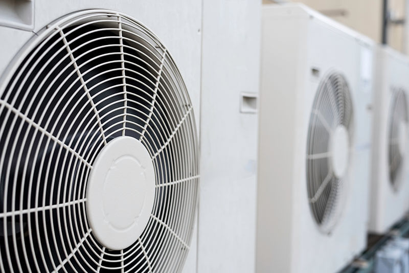 Close up fan cage white mini-split condensers