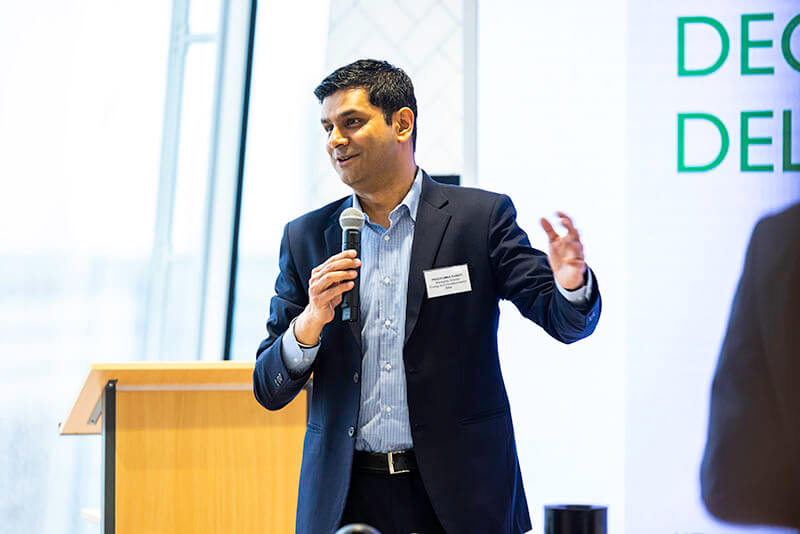 Prad Pandit, Managing Director of Sustainability and Energy at Mitie, speaking at a Decarbonisation Delivered breakfast briefing
