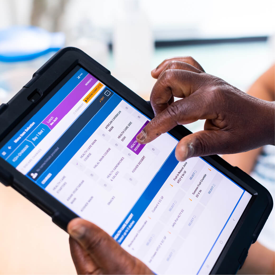 Nurse using a Mitie iPad to select a patient's menu choices