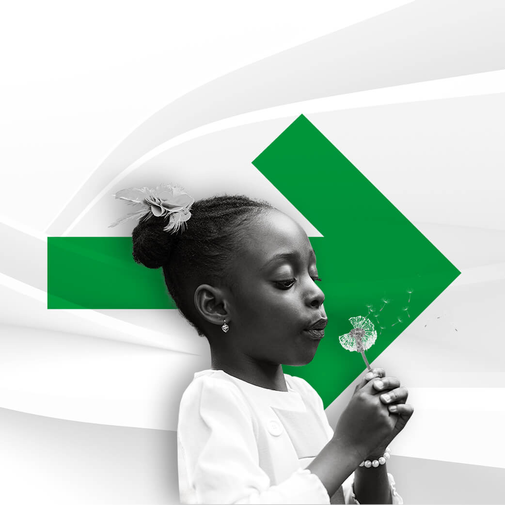 Black girl blowing a dandelion, in front of a large green arrow