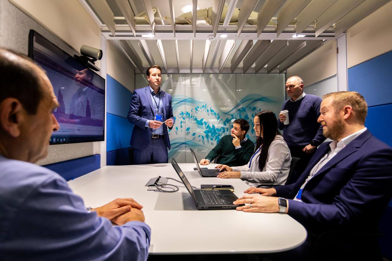 Group of men and women in an office meeting