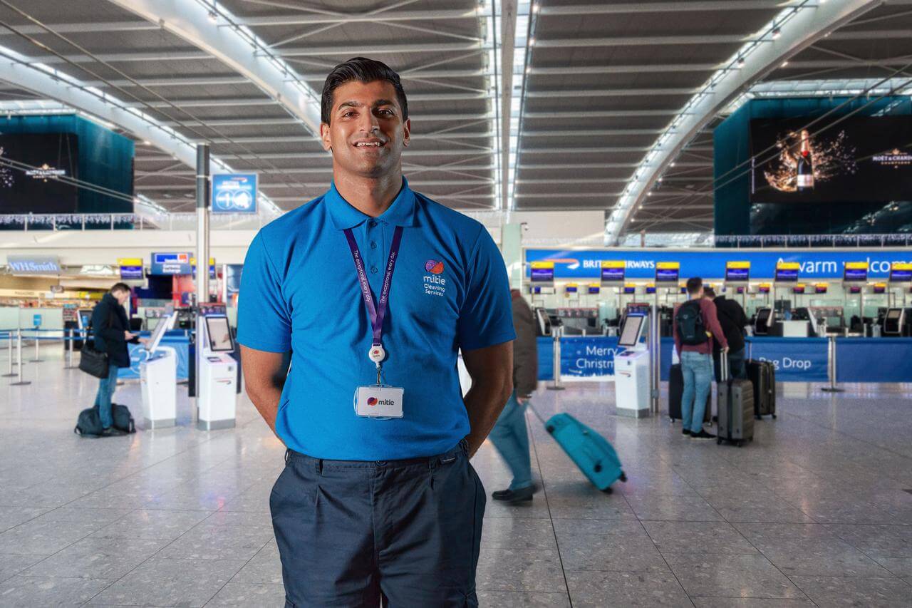 Mitie cleaning colleague standing in a UK airport terminal