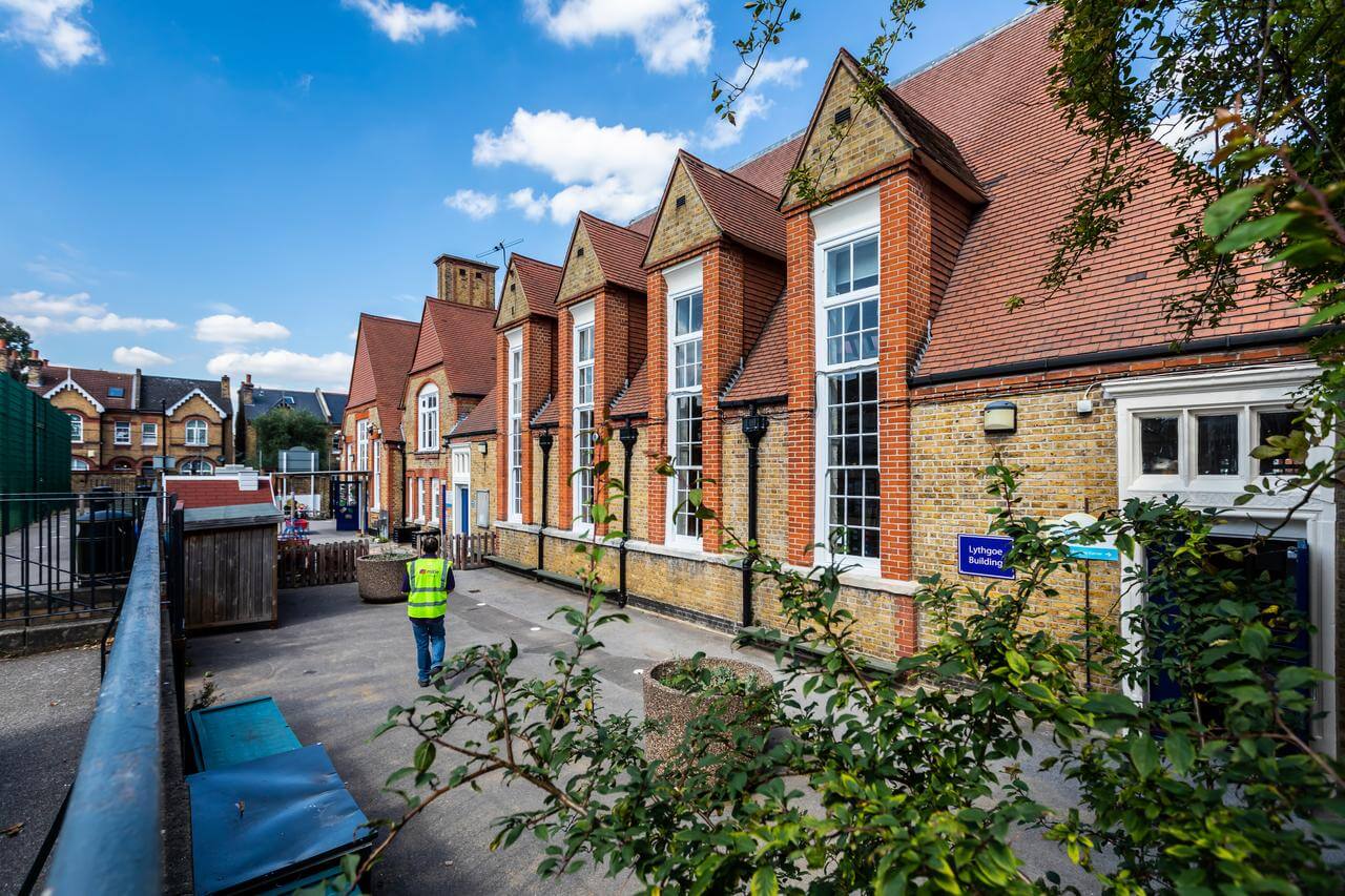 Mitie worker in a high-vis vest visiting a school building