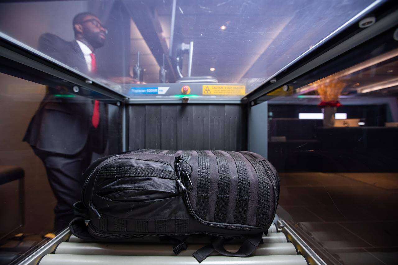 A black bag being inspected in a security scanner