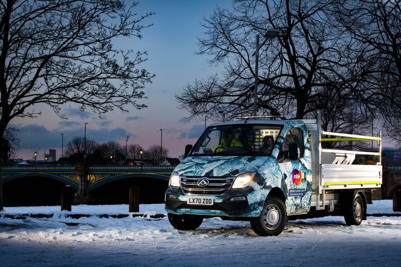 Mitie van, with a snowflake branding, on a road covered in snow