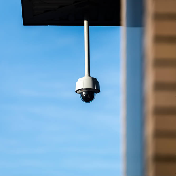 Security camera against a blue sky