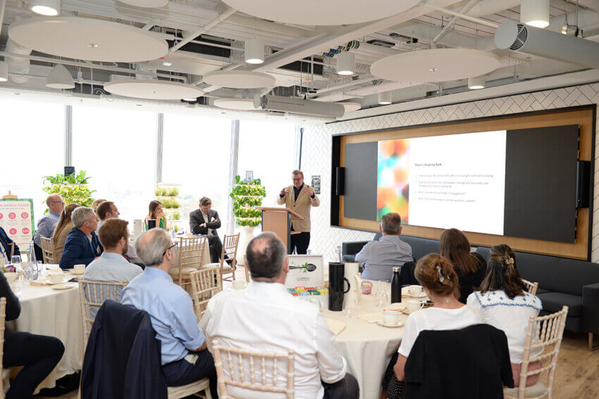 Antony Slumbers presenting at the front of an Estate Optimisation event at Mitie offices in the Shard, London,