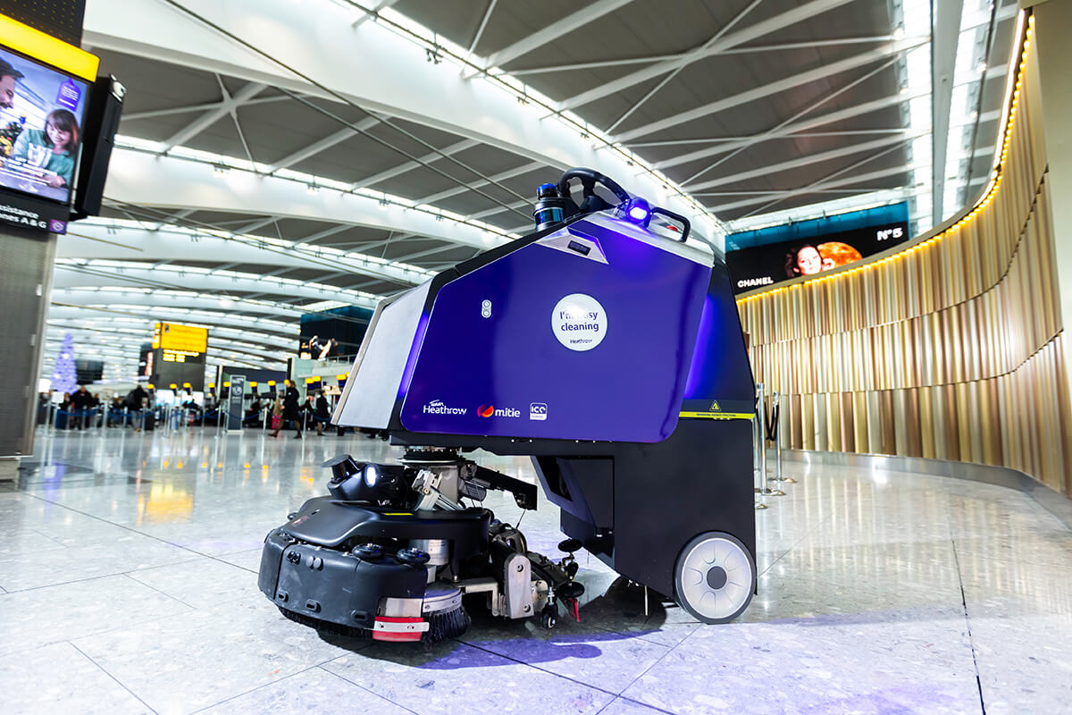 A purple cleaning robot in a terminal at Heathrow Airport