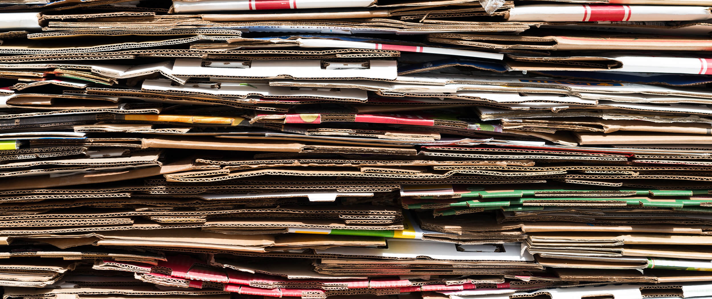 Close-up of discarded cardboard boxes folded flat