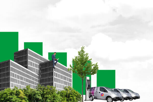 An illustration of a man in a suit sitting on top of a grey and glass office building, while working on a laptop. Green treetops are nearby, and three Mitie-branded vans are electrically charging on the right-hand side. A green bar graph descends in the background