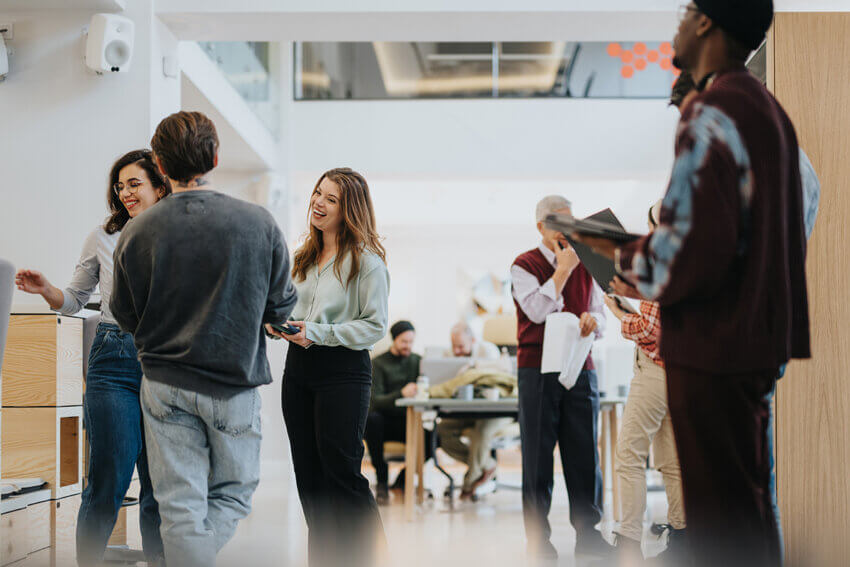Casual business colleagues conversing in a modern office environment