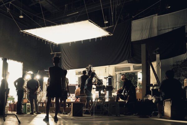 Silhouette of people working in big production studio