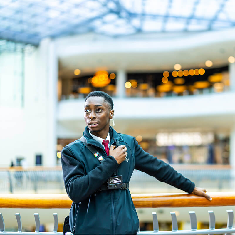 Mitie security guard using his radio