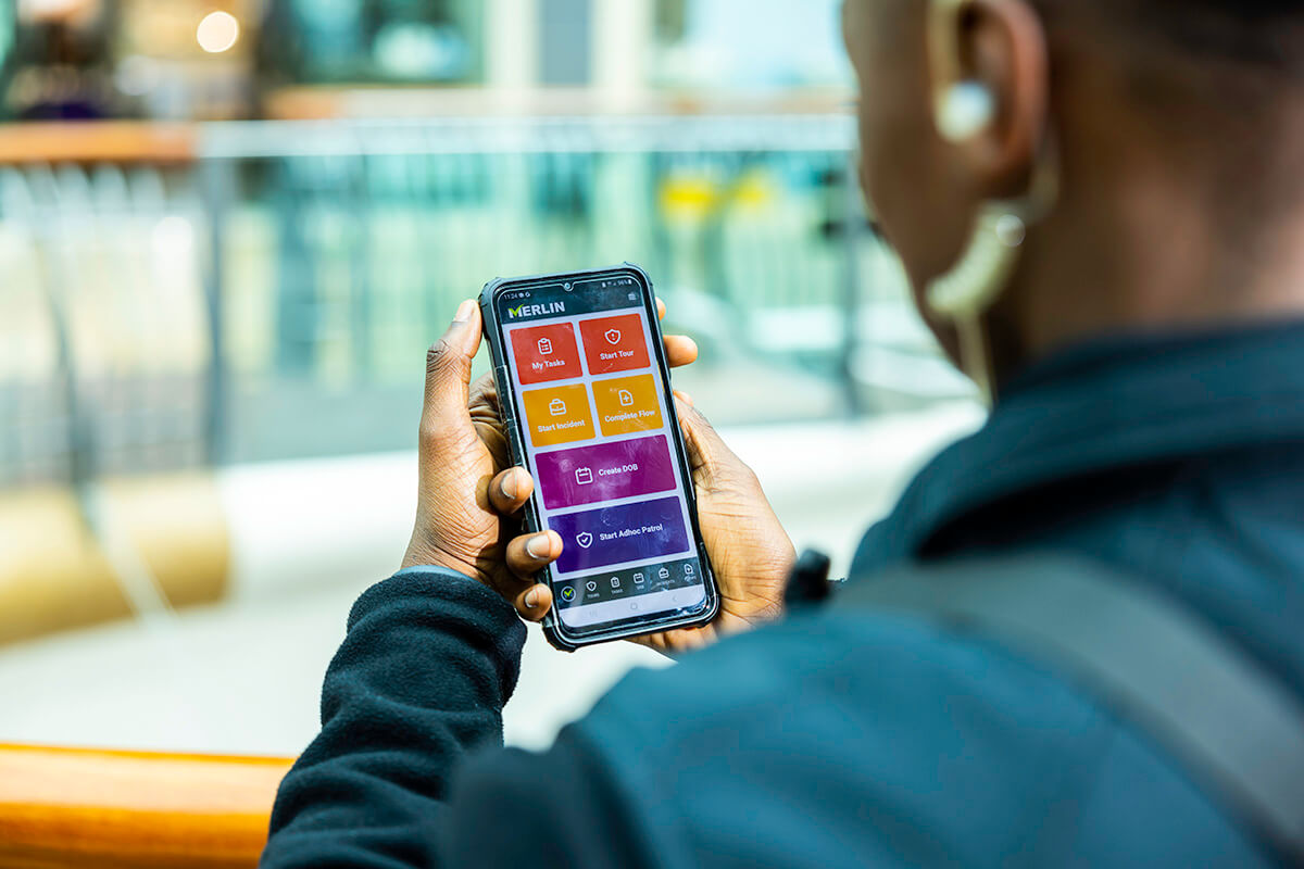 Mitie security guard using the Merlin app