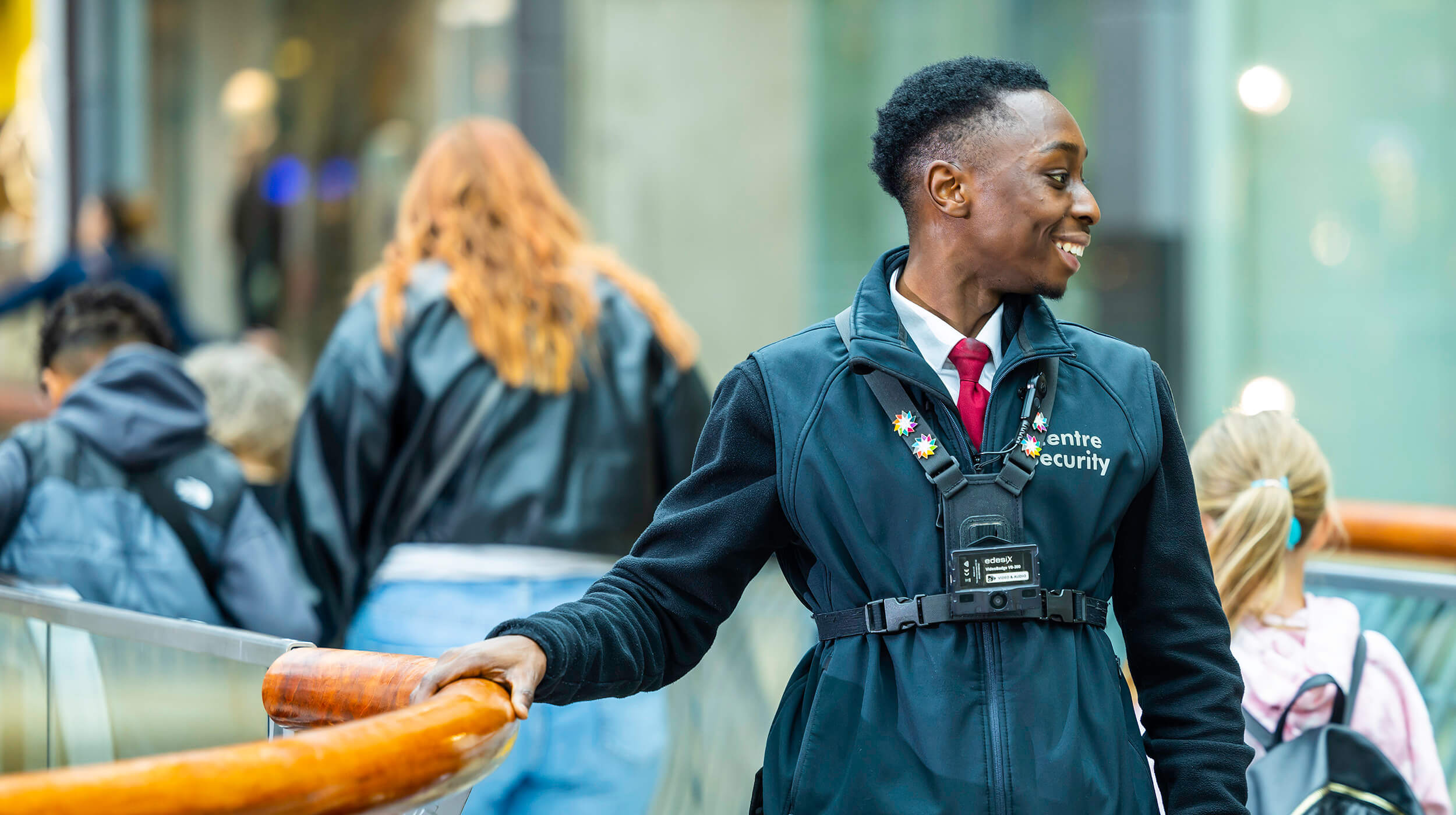 Smiling Mitie security guard in a shopping centre