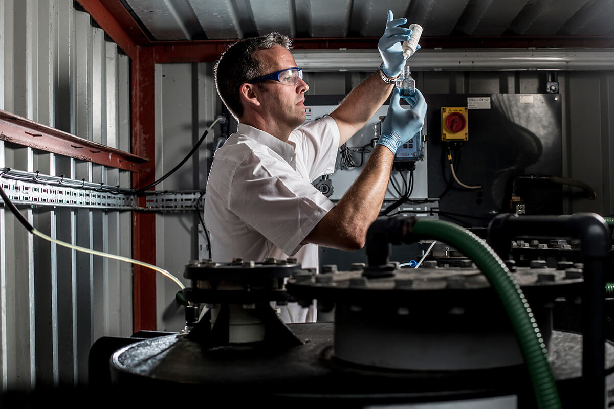 Man chemically testing water samples