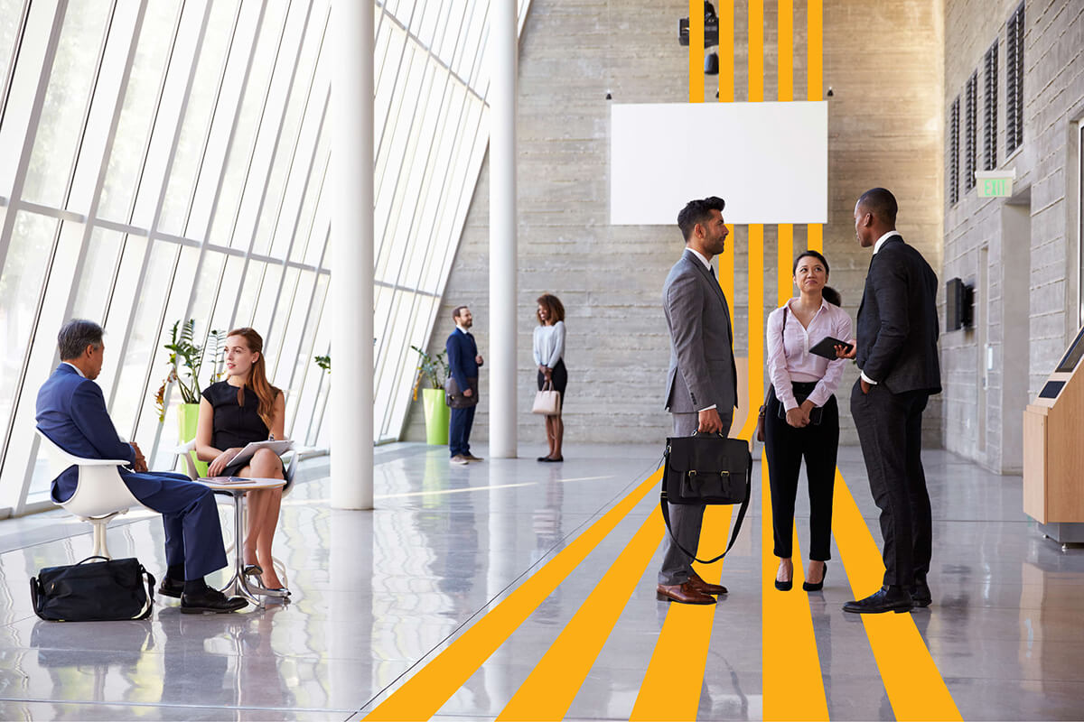 A modern office space with a yellow wavy line surrounding workers