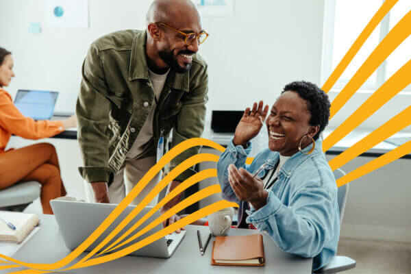 Two people laughing in an office with yellow wavy lines between them