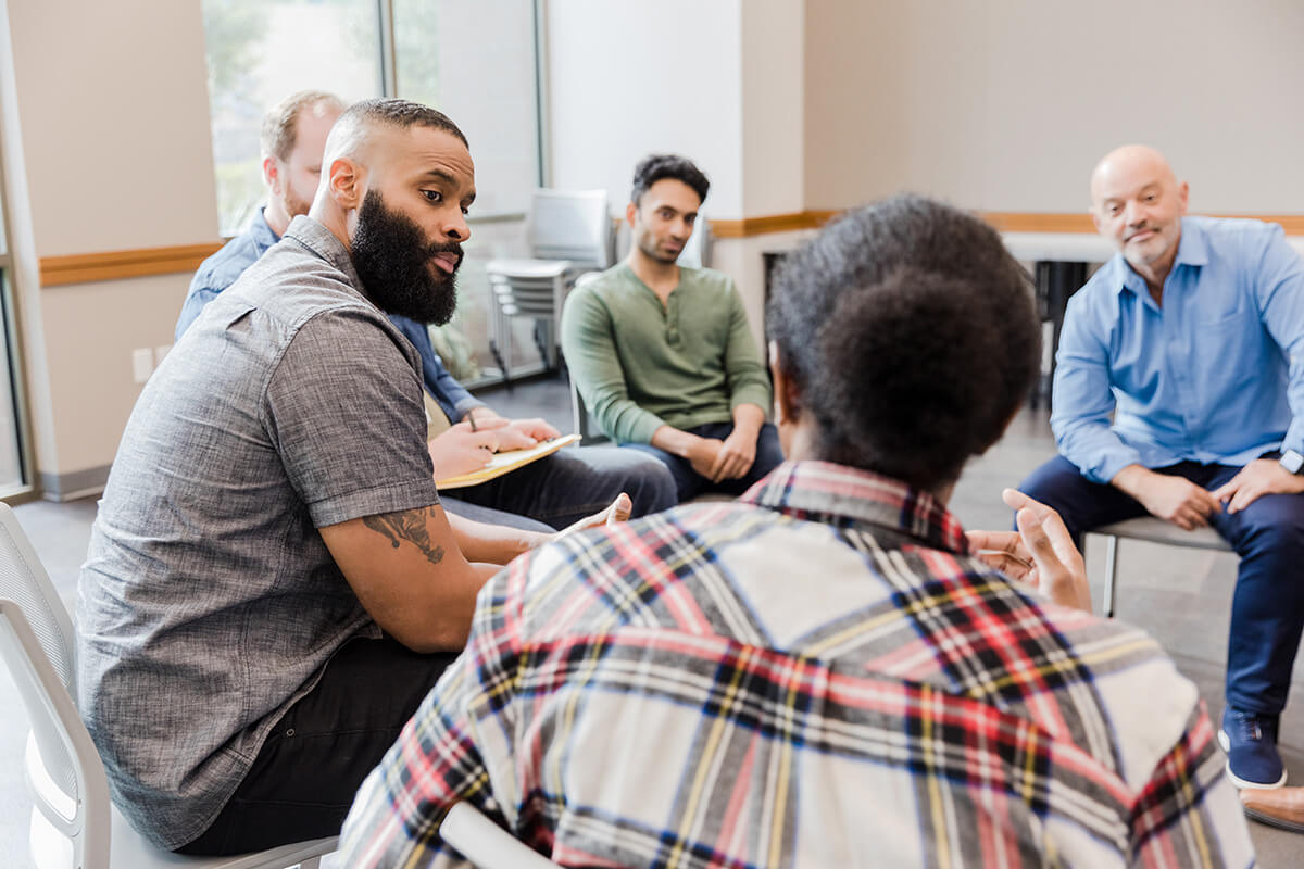 Group of men talking in a circle