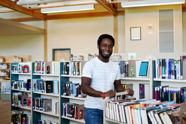 Man pushing the book cart in a prison library