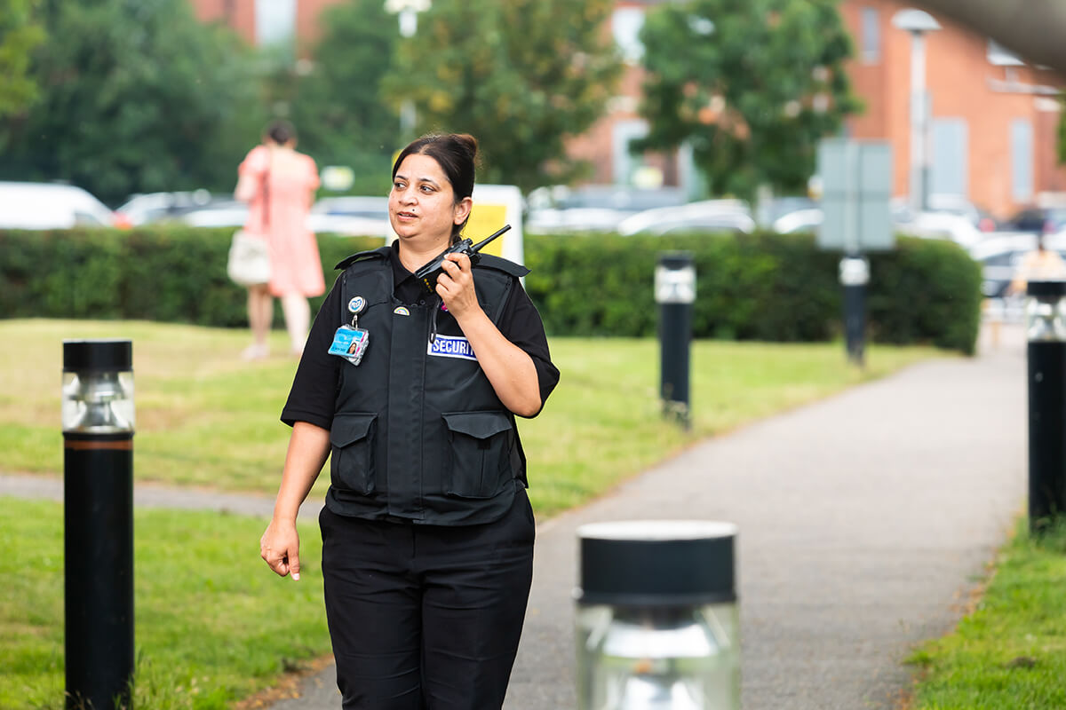 Mitie female security guard in a park