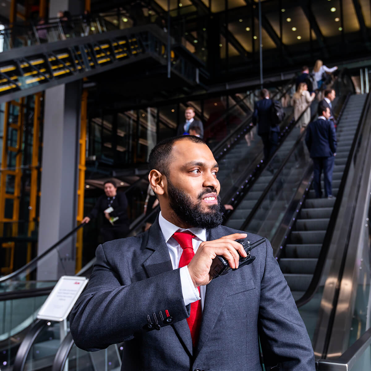 Mitie security guard at the bottom of an escalator