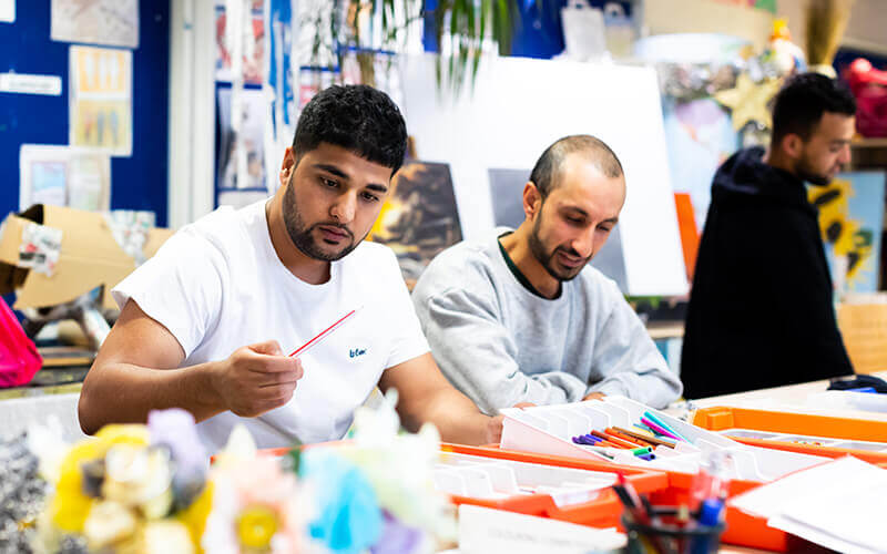 People doing art at an immigration centre
