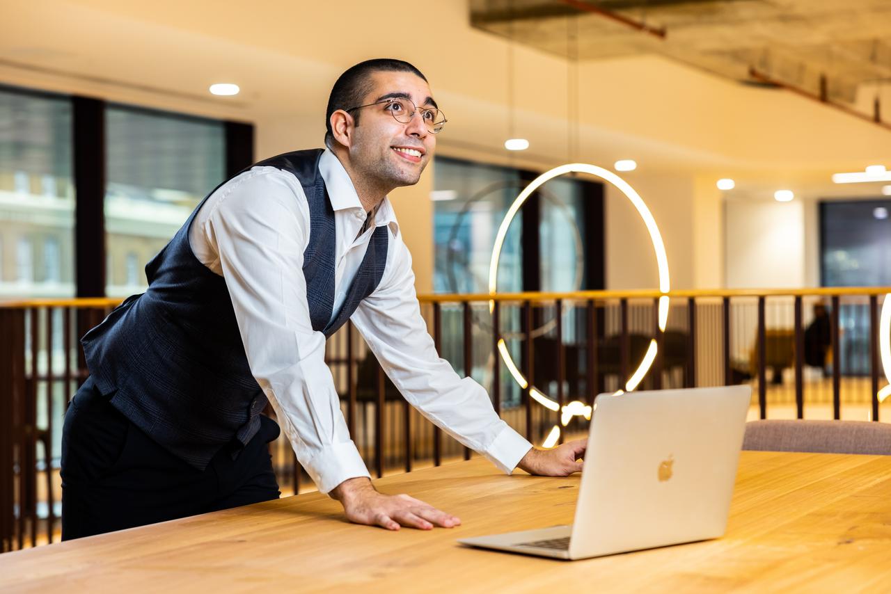 Guest services colleague setting up meeting technology with a laptop