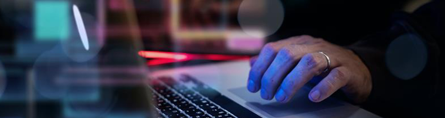 Close up of a hand using a laptop