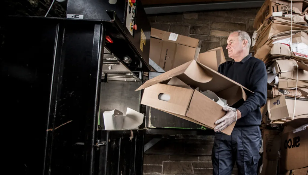 Mitie collegue handles paper waste