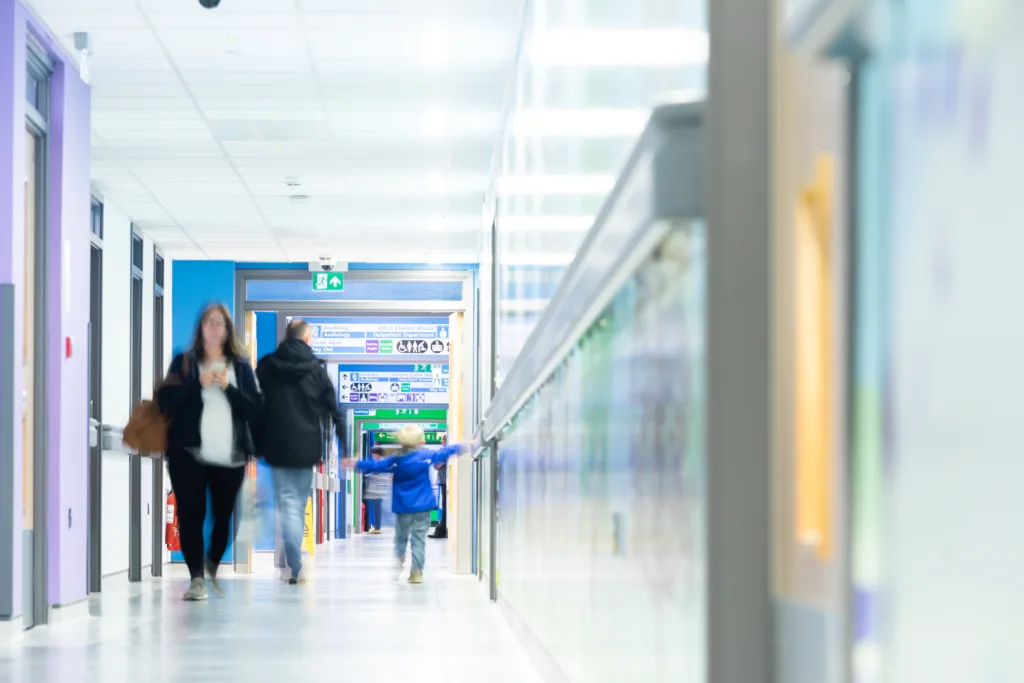 People in a hospital corridor