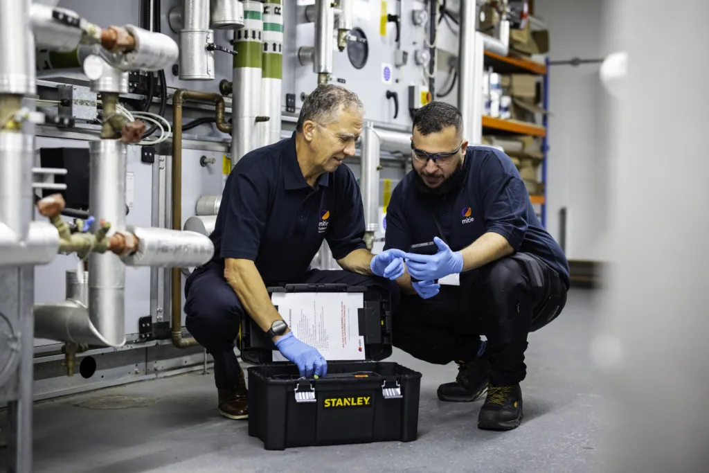 Two Mitie engineers in a plant room