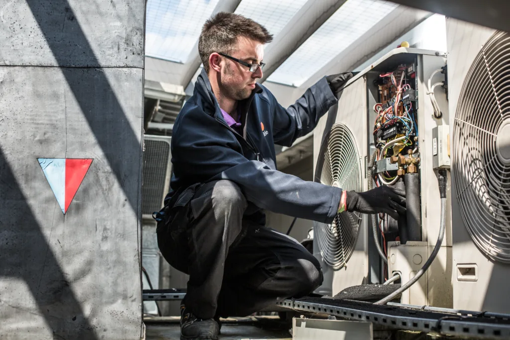 Mitie engineer fixing AC unit