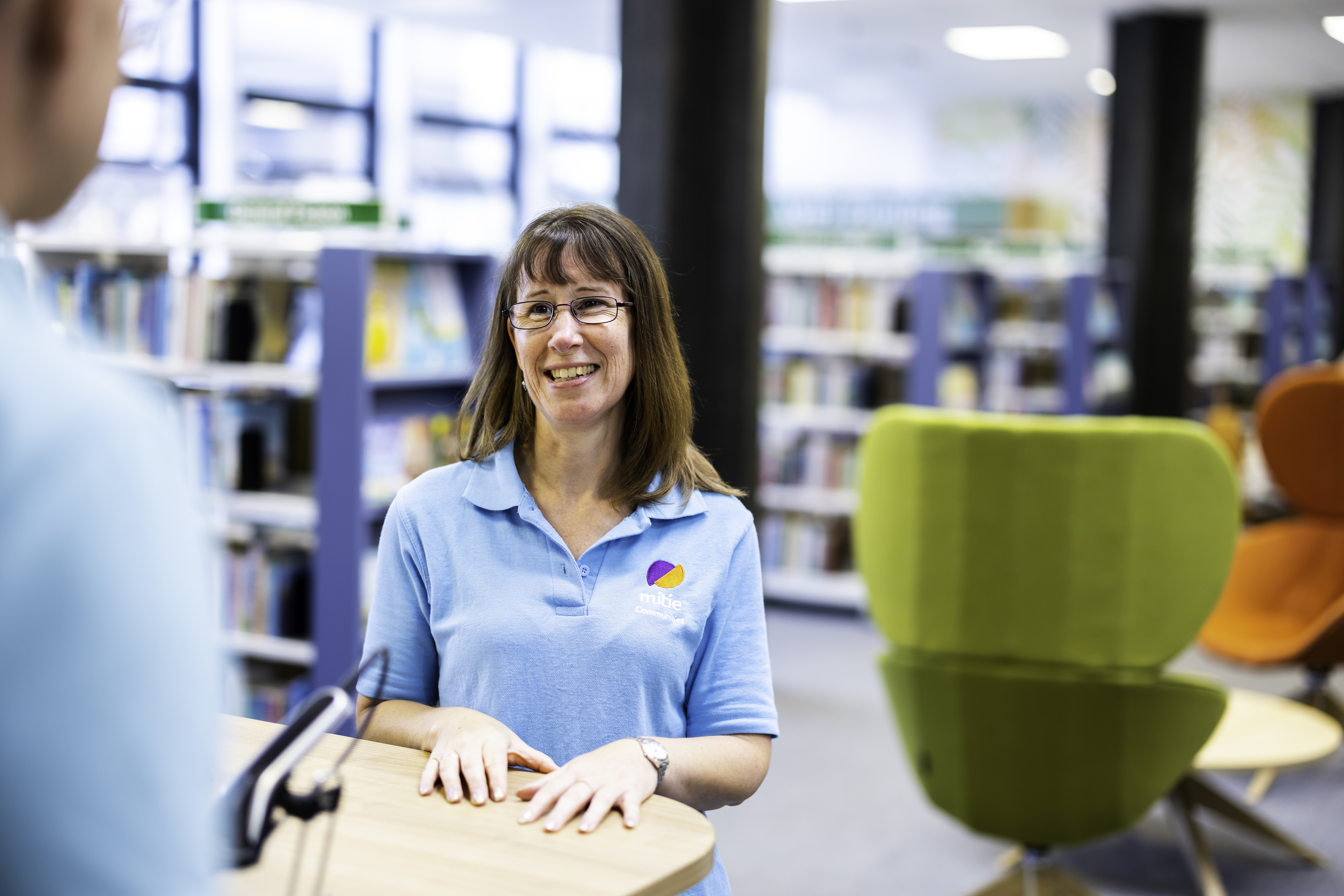 Mitie colleague smiling in a library