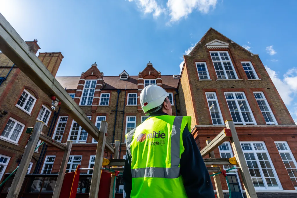 Mitie Projects colleague looking up a school building
